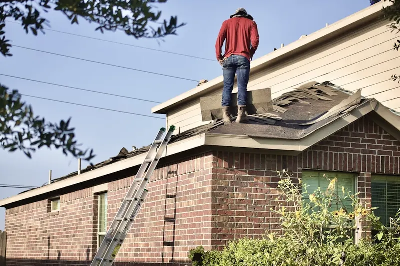 Professional roofer working on a residential roof in Eastham